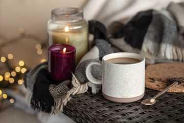 Cozy home composition with a cup of coffee and candles.
