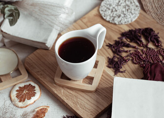 A beautiful cup with a drink on a wooden stand with decor details top view.