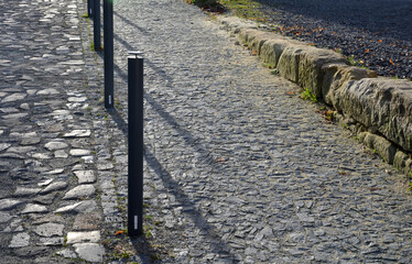 mosaic of small marble cubes. sidewalks and squares formed by stone carpet with squares, polka dots...