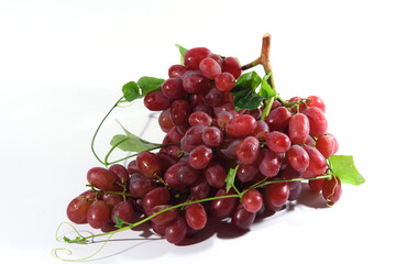 Fresh grapes and purple grape juice on the White background./Bunch of Grapes with water dropletsr