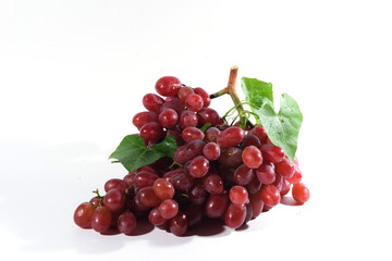 Fresh grapes and purple grape juice on the White background./Bunch of Grapes with water dropletsr