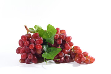 Fresh grapes and purple grape juice on the White background./Bunch of Grapes with water dropletsr