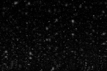 Falling snowflakes on black background