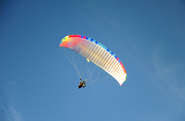 Paragling man in the blue sky