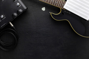 Desk of musician for songwriter work set with headphones and guitar