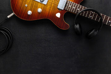 Naklejka premium Desk of musician for songwriter work set with headphones and guitar
