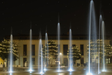 Christmas night, fountains at Ferdinando di Savoia square, starry sky, Peschiera del garda, Italy.