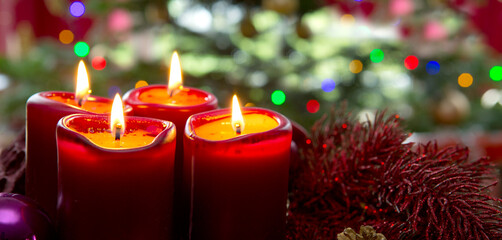 Four red candles for Advent. Christmas background.