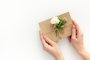 Hands hold craft envelope with flowers