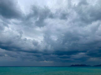 Naklejka na ściany i meble Dark clouds on the sea