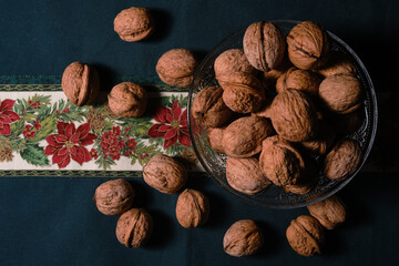 Christmas sweets with nuts and almonds over a christmas tablecloth