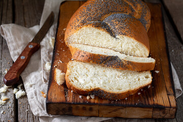 Poppy seed bun. Bread with poppy seeds on a wooden background. Homemade cakes with poppy seeds