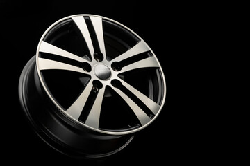 new black matte alloy wheels, close-up on a dark background. spokes of the disk with a silver groove. side view