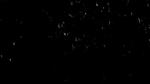 Background with raindrops on a black background for overlay to create mood. Light water on glass isolated on a dark background.