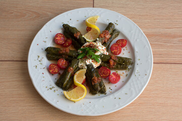 Olive oil lemon vine leaves, top view, turkish sarma or dolma.