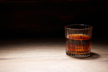 Whiskey in glasses on wooden table