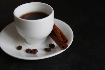 Coffee cup and saucer on a wooden table. Dark background