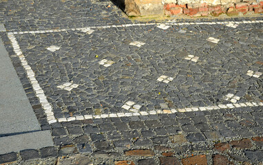 mosaic of small marble cubes. sidewalks and squares formed by stone carpet with squares, polka dots...