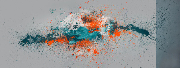 big colorful abstract orange, turquoise, white color spot on two tone gray background, multicolor paint splash in studio, leave an exciting pattern