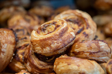 Small Danish pastries with raisins, chocolate chips, and vanilla cream, sold in a sweets store