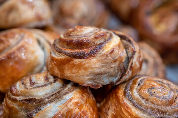 Small Danish pastries with raisins, chocolate chips, and vanilla cream, sold in a sweets store