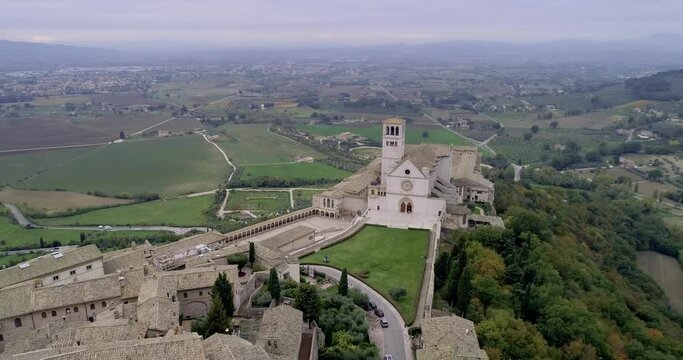 Aerial drone view of Assisi, "City of Peace" in Umbria, Italy. panoramic views of the city and details of the symbolic buildings of the city with the famous Basilica of San Francesco.