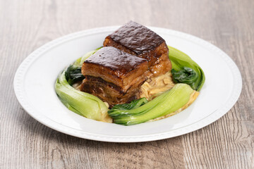 Dong Po Pork meat in a blue plate with broccoli with red background.