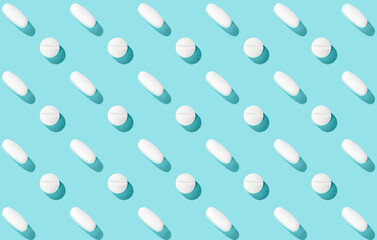 Trendy pattern with medical pills on light blue background, copy space. Medicine creative concept. Minimal style. Top view, flat lay