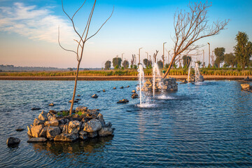 An artificial lake in the middle of the desert in UAE. Beautiful view of man-made lake and blue sky...