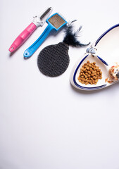 A set of accessories for cat grooming on white background.   Flat lay. 