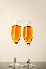 Two glasses of champagne on a gray background. Alcoholic drink: champagne, beer, white wine. New year and Christmas background. Valentine's Day. Vertical photo
