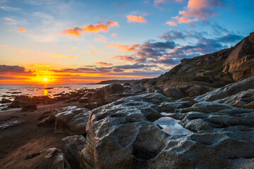 Colorful sunrise on the rocky coast