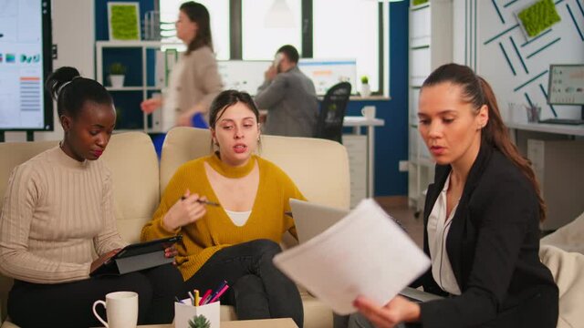 Group of diverse startup company colleague entrepreneur meeting in professional workplace, brifing and sharing ideeas over financial strategy management. Happy multiracial business people enjoying