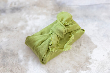 Zero waste gift wrapping traditional Japanese furoshiki style. Reusable wrapping concept. Eco friendly presents.