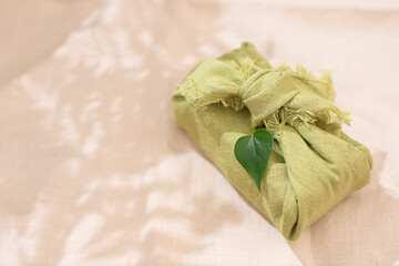 Zero waste gift wrapping traditional Japanese furoshiki style. Reusable wrapping concept. Eco friendly presents.