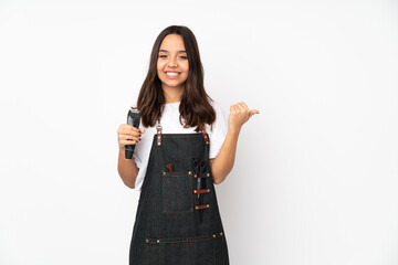 Fototapeta premium Young hairdresser woman isolated on white background pointing to the side to present a product