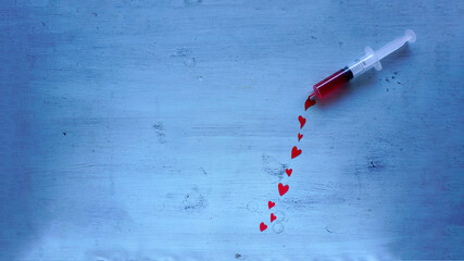 Love injection on a blue wooden background