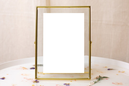Retro gold or bronze frame with scuffs aged for photos, text, images or paintings on white table
