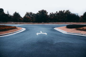 The black asphalt road next to the city's high-rise buildings