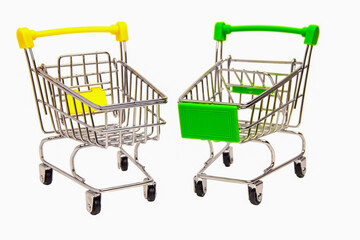 Two empty shopping cart with green handle and yellow handle isolated on white background