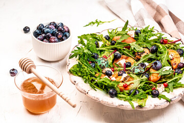 Arugula and peaches salad. Vegetarian gourmet salad made of caramelized grilled peaches slices,...