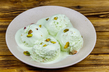 Pistachio ice cream on wooden table