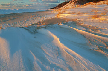 Winter landscape of the frozen shoreline of Lake Michigan near sunset, Saugatuck Dunes State Park, Michigan, USA