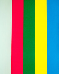 Sheets of multi-colored paper folded one by one and formed straight parallel lines. Pop-art.