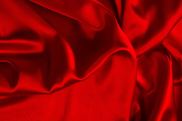 Red silk or satin luxury fabric texture can use as abstract background. Top view.