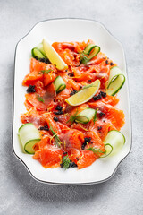 Slices of homemade smoked salmon fillet with dill and lemon