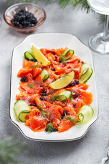 Slices of homemade smoked salmon fillet with dill and lemon