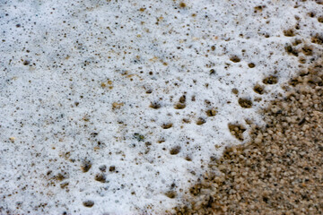 Waves sweeping against the rocks and the beach