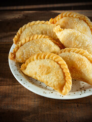 Fried beef patties or pies on rustic wooden table