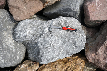 Geological Hammer on raw limestone in the natural background. Pointed-Tip Rock Picks